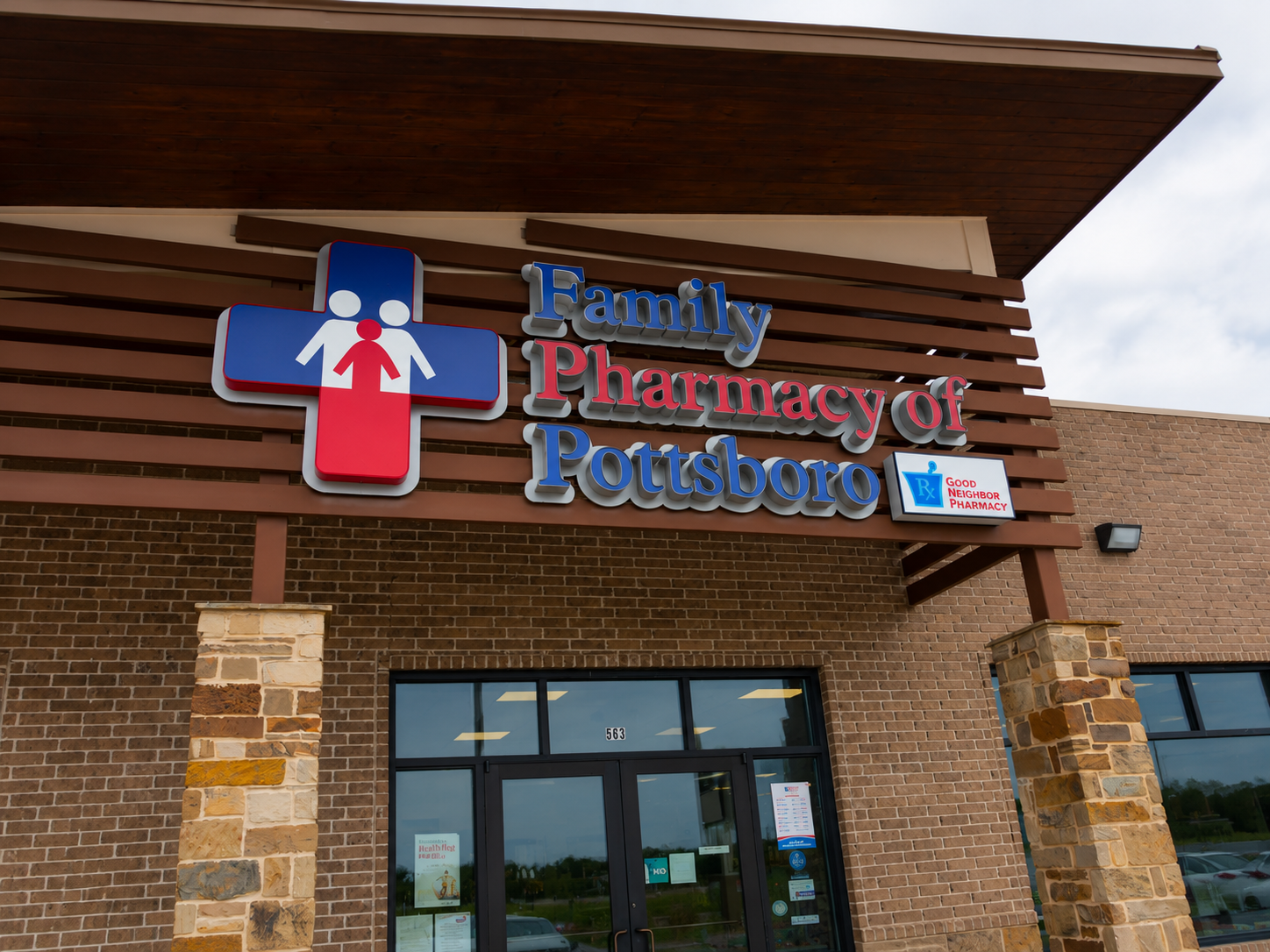 The exterior of Family Pharmacy of Pottsboro showing the storefront sign and brick entrance